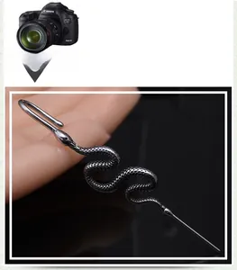 Detailed macro view of punk style snake earring with realistic scale texture and dark finish