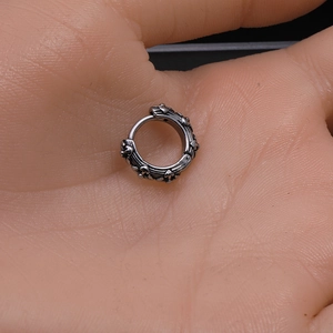 Retro stainless steel clicker hoop earring with black star sun pattern on palm