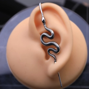 Silver snake ear cuff earring with detailed scales on a realistic ear display