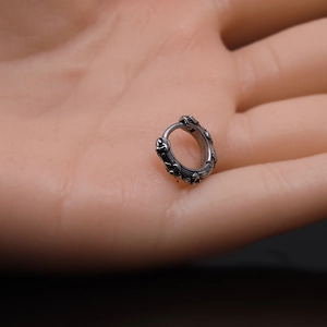 Vintage stainless steel ear hoops with intricate engraved vine patterns in silver finish