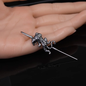Industrial barbell piercing in stainless steel with a vintage tiger design and polished finish