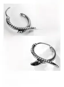 Macro detail of titanium steel snake hoop earring showing textured scales and polished finish