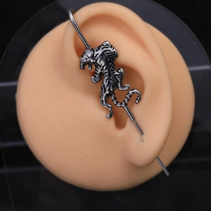 Industrial piercing bar with a vintage stainless steel tiger on a silicone ear model