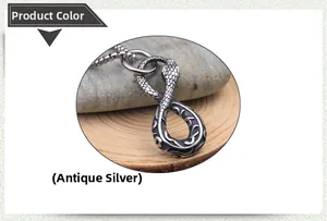Macro detail of antique silver snake pendant with textured scales on a box chain