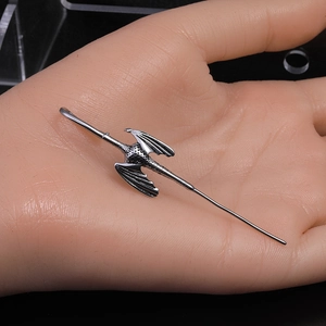 Pterodactyl shaped stainless steel ear cuff earring in vintage silver finish on hand