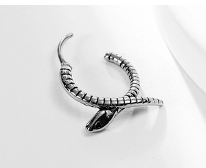 Macro detail of silver snake hoop earring with vintage textured scales and hip-hop style
