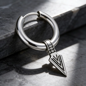 Macro view of retro punk stainless steel hoop earring with spearhead arrow pendant