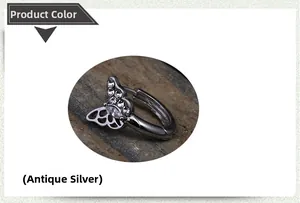 Detailed macro view of antique silver butterfly earring with shimmering cubic zirconia