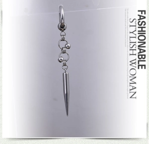 Detail of silver long drop earring featuring cross chain and conical bullet pendant
