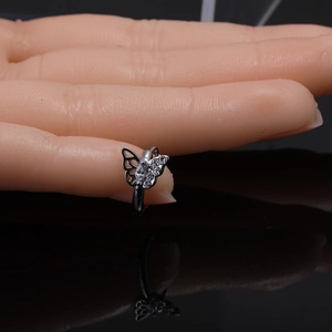 Detail of silver butterfly earring featuring sparkling crystal inlays and metallic finish