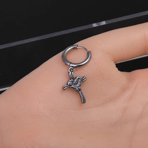 Detailed macro view of a vintage black cross hoop earring with a heart-shaped center motif