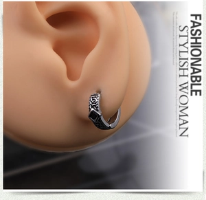 Detailed view of vintage steel earring with black square stone on silicone ear model