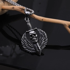Detail of gothic punk skull pendant with sword and wings on a silver steel box chain