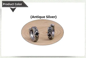 Detail of vintage silver stud earrings with black square stone and Celtic knots