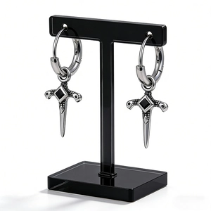 Men's silver stainless steel dagger earrings with black onyx on a studio display