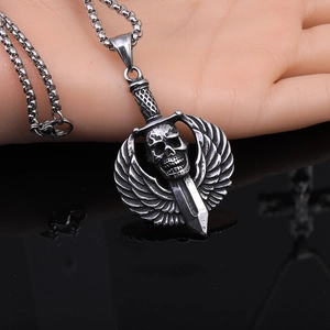 Macro detail of punk skull pendant with wings and sword on a durable box chain necklace