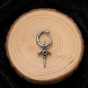 Close-up of vintage stainless steel hoop earring with sword pendant and black gemstone