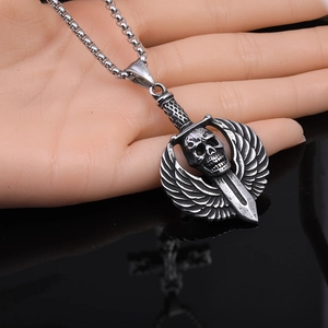Detailed view of punk gothic skull wings dagger pendant on a stainless steel bead chain