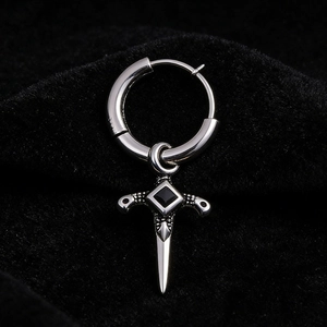 Detailed macro view of silver steel hoop earring with black gemstone sword pendant