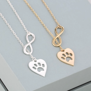Collier cœur infini avec empreinte de patte en or et argent sur un support