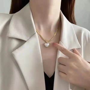 Elegant gold-plated heart necklace with mother-of-pearl inlay on a sleek snake chain