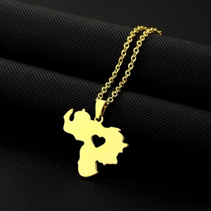 Close-up of gold Venezuela map necklace with hollow heart detail on black mesh