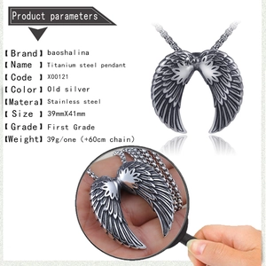 Macro view showing vintage silver angel wings pendant details and dimensions