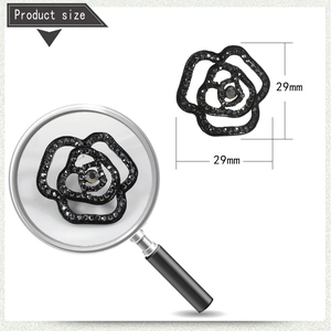 Detail view of black rose brooch with crystals and size markings of 29mm x 29mm
