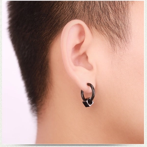 Close-up of minimalist black square drop earrings worn to show style and size