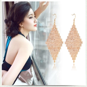 Détail de boucles d'oreilles losanges dorées avec strass sur mannequin et vue rapprochée