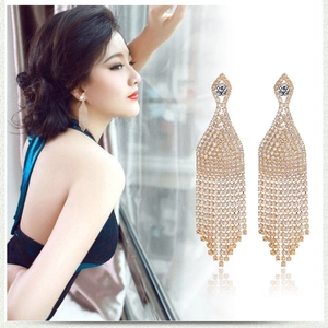 Macro detail of luxury silver tassel earrings with sparkling rhinestones and crystal drop