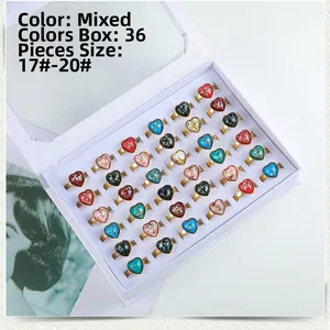 Detail of 36-piece box set featuring golden heart rings with multi-color stones in sizes 17-20
