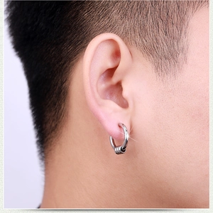 Close-up of silver punk hoop earring for men with three dangling rings on male model