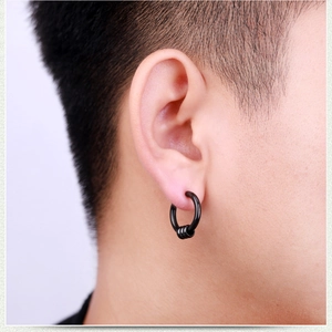 Close-up of minimalist black hoop earrings with three moving rings worn by male model