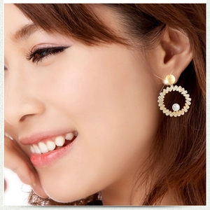 Elegant gold pearl hoop earrings with rectangular diamonds on a female model