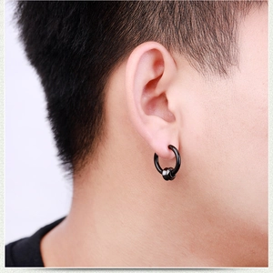 Close-up of a men's black stainless steel hoop earring with two sliding small metal beads