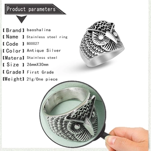 Macro detail of antique silver owl ring with engraved feathers and stainless steel stamp