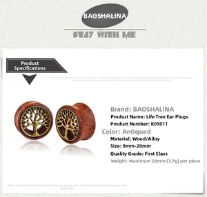 Detail view of vintage wooden ear gauges with antique metal tree of life inlay design