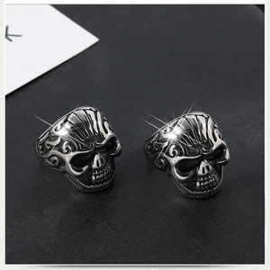 Close-up of retro silver skull rings with punk engravings and vintage oxidized finish