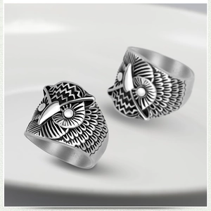 Detailed close-up of retro owl rings with oxidized silver finish and intricate feathers