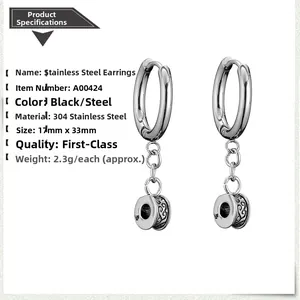 Detail of 304 stainless steel hoop earrings featuring an embossed round pendant design