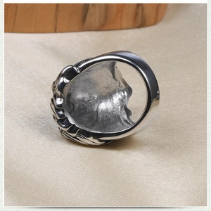 Detailed close-up of a vintage skull ring with intricate relief and polished inner band
