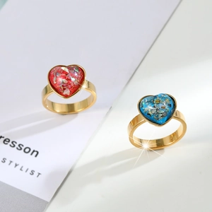 Elegant gold-plated heart rings with sparkling red and blue stone insets in a stylish pair