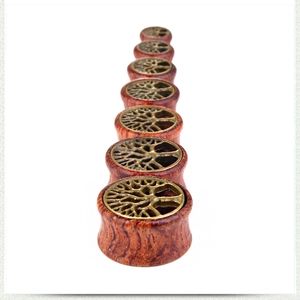 Detailed set of seven wooden ear plugs with vintage bronze tree of life metal inlays