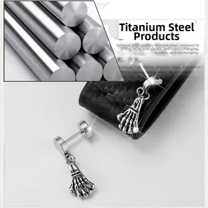 Punk style stainless steel hoop earrings featuring a skull hand dangle charm for men