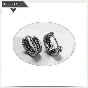 Macro shot of antique silver stainless steel hoop earrings with woven texture detail