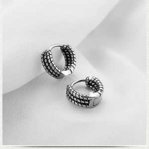 Unisex stainless steel huggie hoop earrings with vintage bamboo texture on white cloth
