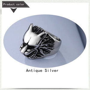 Detail of antique silver wolf head ring with vintage texture and engraved animal fur details