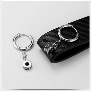 Polished titanium steel hoop earrings featuring hanging chains and engraved cylinder charms