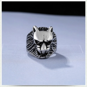 Macro shot of vintage silver wolf head ring with detailed fur texture and gothic style